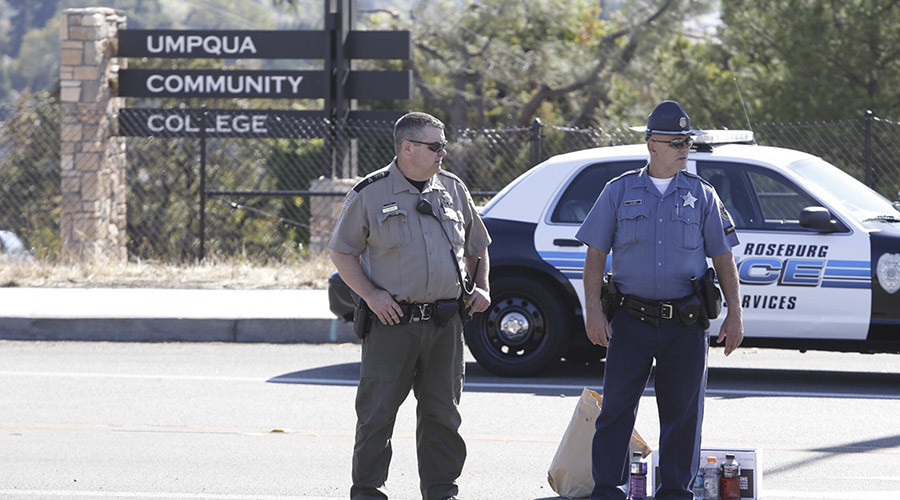 Police officers stand guard near the site of a mass shooting at Umpqua Community College in Roseburg Oregon